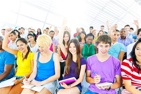 60 College Students Raising Hands In Crowded Lecture Hall Stock Photos