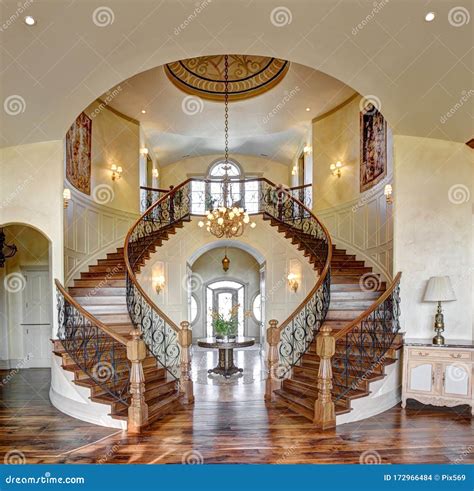 The Curved Dual Grand Staircase In An Upscale Home Stock Photo Image