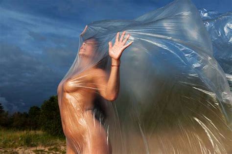 Beautiful Body Of Nude Woman On Nature Background Under Plastic Wrap