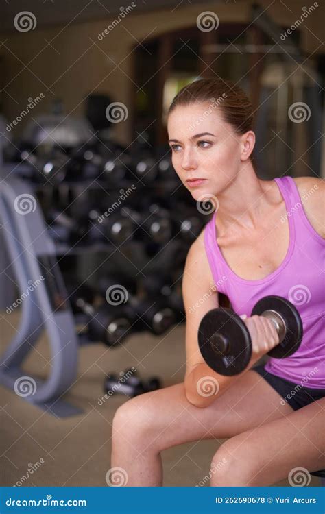 Shes Getting Fit For Summer A Serious Woman Exercising Her Arms With