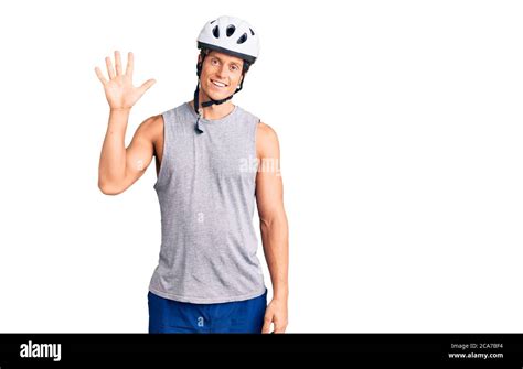 Young Handsome Man Wearing Bike Helmet Showing And Pointing Up With