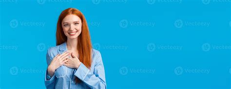 Feminine Lovely Redhead Woman With Long Ginger Hair Wearing Pyjamas Hold Hands On Heart And