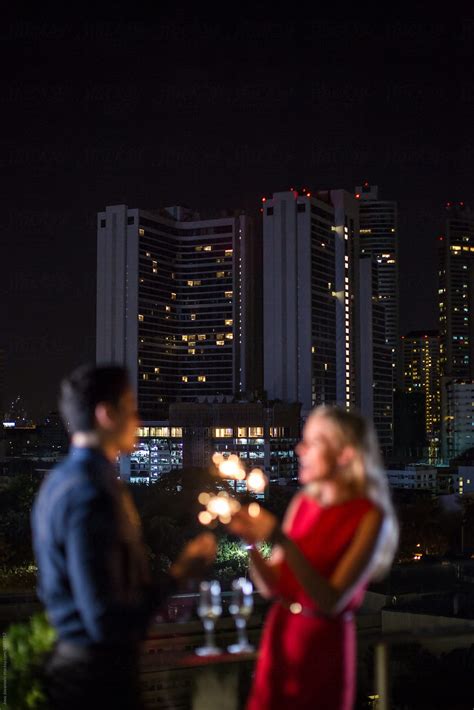 Couple On A Rooftop Celebrating New Year S Eve By Stocksy Contributor