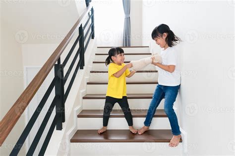 two little girl fighting over bear 13069914 Stock Photo at Vecteezy
