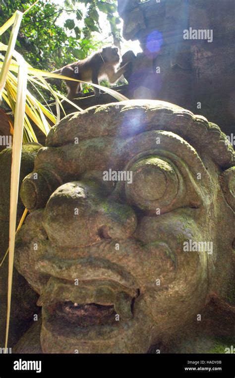 Monkeys Having Fun On Stone Statues Of Hindu Holy Monkey Forest Ubud