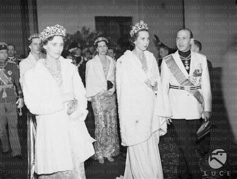 An Old Black And White Photo Of Several People In Formal Dress With