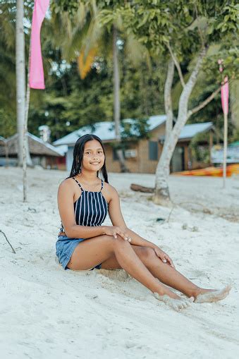 Portrait Of A Beauitful Brown Skin Filipina Model On A White Sand Beach In The Philippines Stock