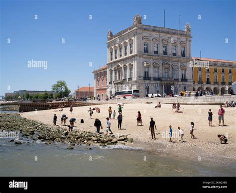 Tourists enjoying the beach near Cais das Colunas at Terreiro do Paço