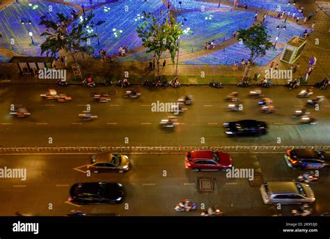 Bright Lights Aerial View Of Nightlife And Moving Traffic By Saigon