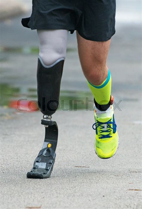 Man running with prosthetic leg on the ... | Stock image | Colourbox