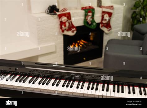 A piano with christmas lights and tree Stock Photo - Alamy