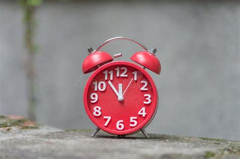 Retro Alarm Clock With Five Minutes To Twelve O Clock Stock Image