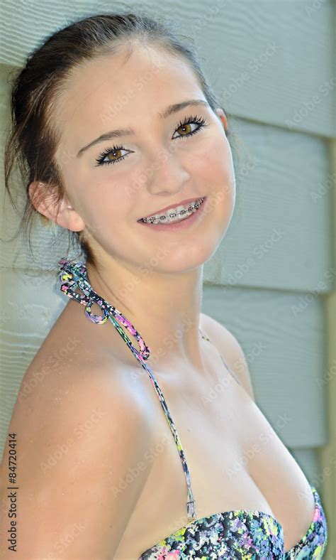 A Pretty Teenage Girl In Bikini Smiling Happily Showing Her Braces