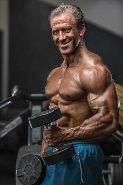 Premium Photo Brutal Aged Strong Bodybuilder Athletic Men Pumping Up