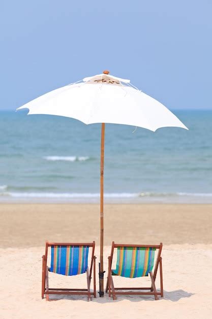 Premium Photo Deck Chairs On Beach Against Sky