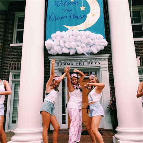 Four Girls Are Dancing In Front Of A Building