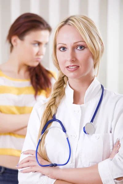 Friendly Female Doctor Touching Patient Shoulder Telling Good Ne