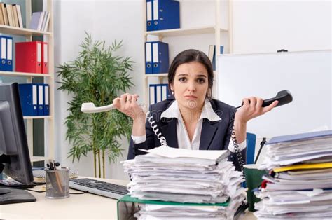 The Female Employee With Too Much Work In The Office Stock Image