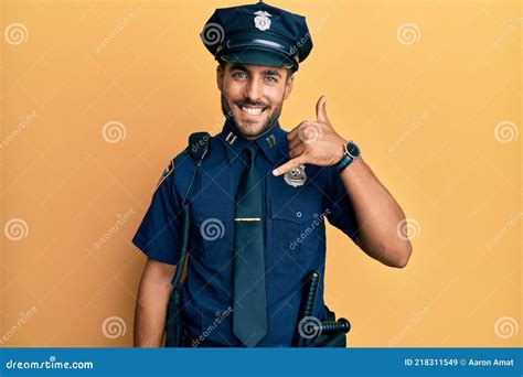 Handsome Hispanic Man Wearing Police Uniform Smiling Doing Phone