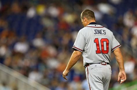 A Baseball Player Standing On Top Of A Field Next To A Crowd At A Game