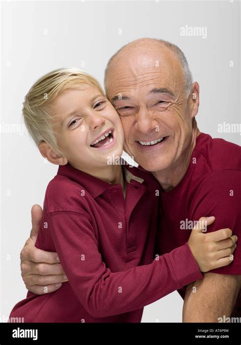 Grandson Embracing Grandfather Smiling Portrait Stock Photo Alamy