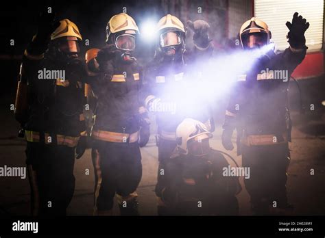 Group Of Professional Firefighters Posing Firemen Wearing Uniforms