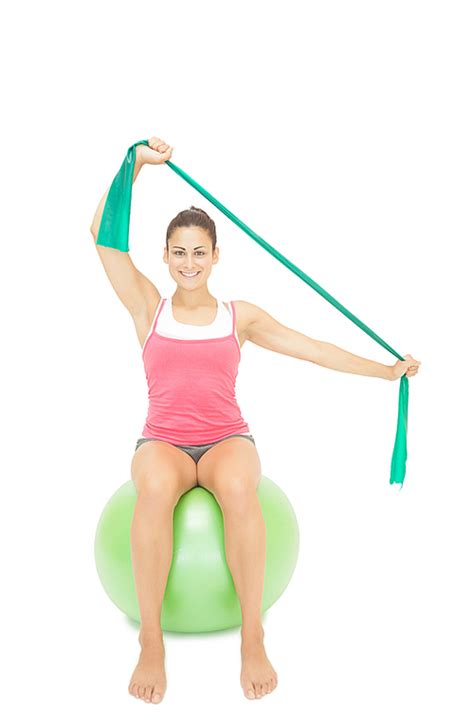 유토이미지 Gleeful sporty brunette stretching with resistance band