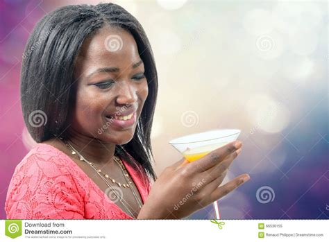 Beautiful African Woman Drinking Orange Juice Bokeh On Background