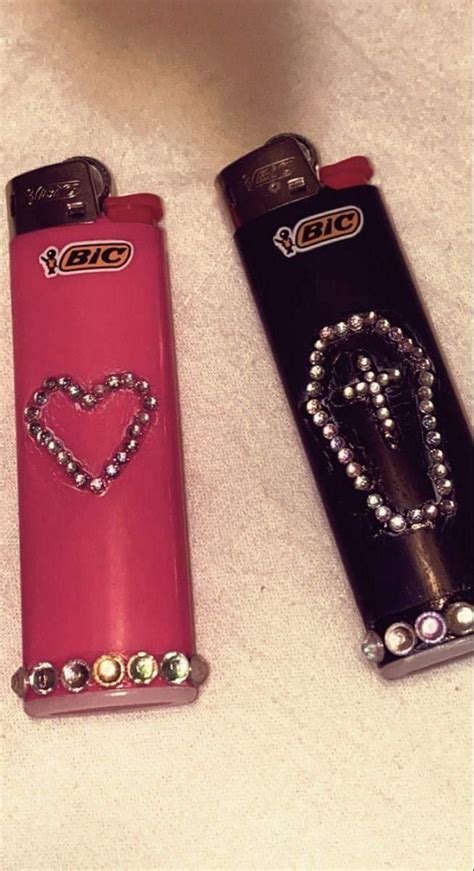 Two Lighters With Designs On Them Are Laying Next To Each Other In The