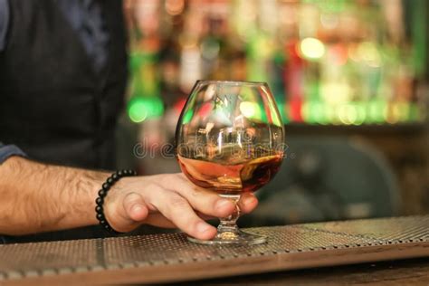 Hand Holding A Glass Of Whiskey At The Bar Stock Photo Image Of