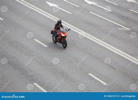 Motorcyclist Rides A Motorcycle On A Multi Lane Highway Stock Photo