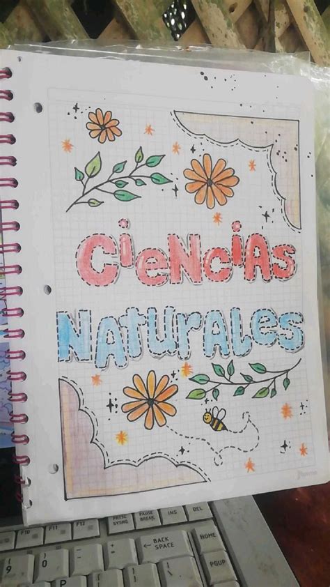 A Notebook With The Words Cienja Naturales Written On It Next To A Keyboard