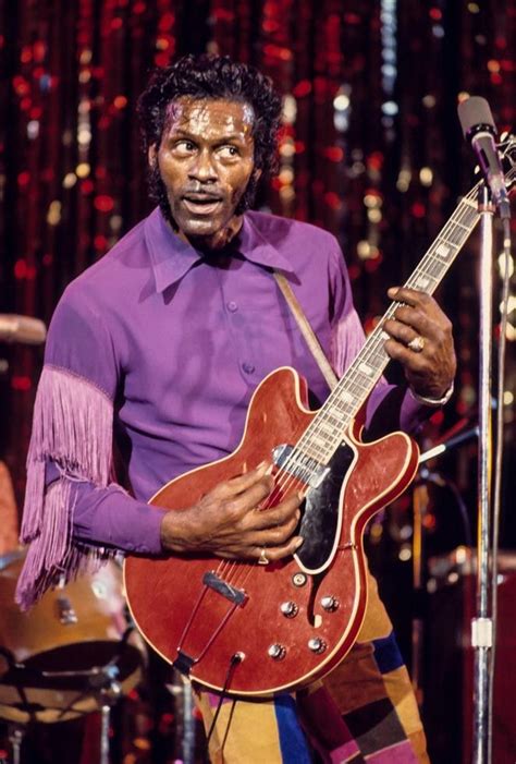 A Man In Purple Shirt Playing An Electric Guitar