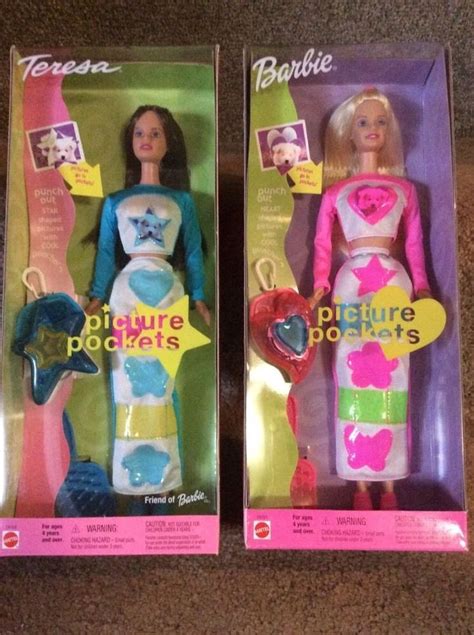 Two Barbie Dolls In Their Packaging On The Floor