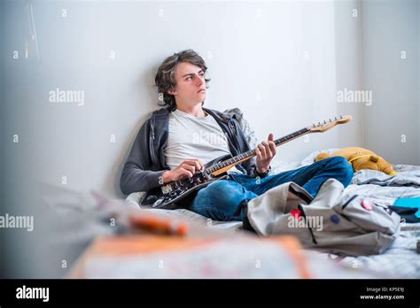 Teenage boy playing electric guitar Stock Photo - Alamy