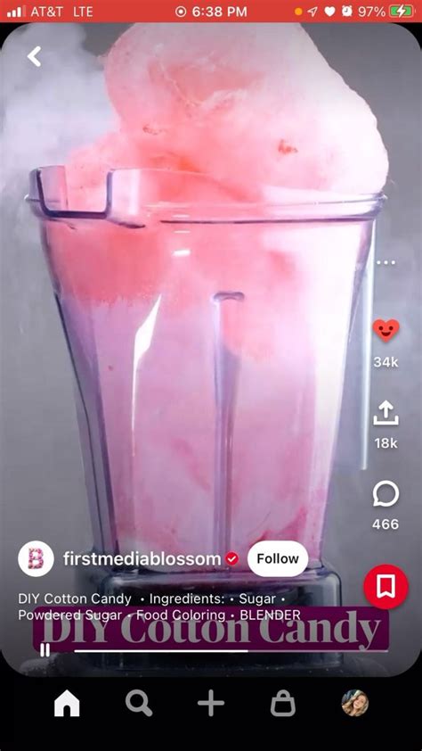 A Blender Filled With Pink Ice Cream On Top Of A Black Counter Next To