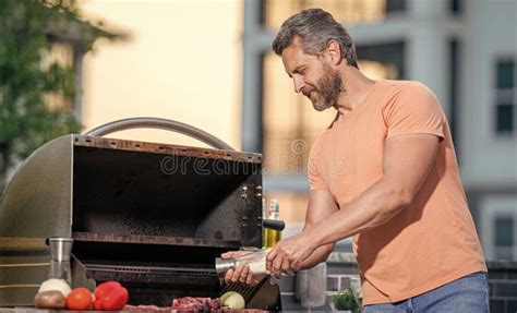 Man Grilling Steaks To Perfection On Smoky Barbecue Grilling Man Cook