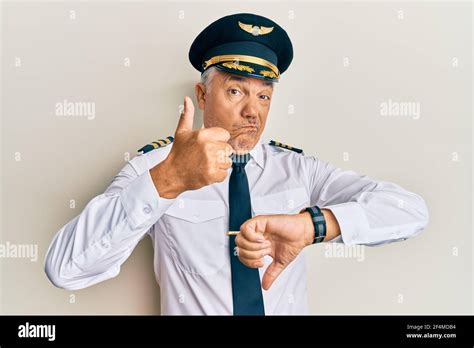 Handsome Middle Age Mature Man Wearing Airplane Pilot Uniform Doing