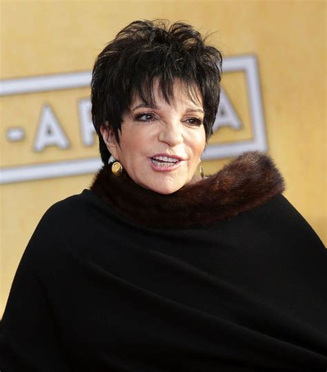 A Woman With Short Hair Wearing A Black Shawl And Fur Stole Around Her Neck