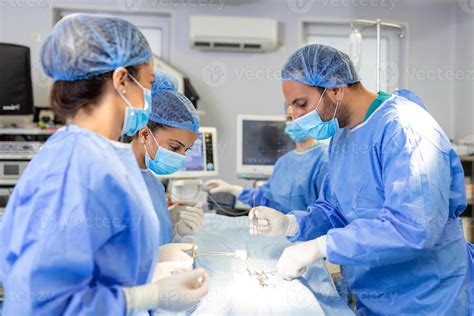 Surgical team performing surgery in modern operation theater,Team of ...