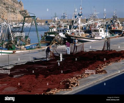 Barcos Pesqueros Anclados Pescadores En El Muelle Reparando Redes