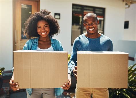 Lets Get Moving Portrait Of A Cheerful Young Couple Holding Cardboard