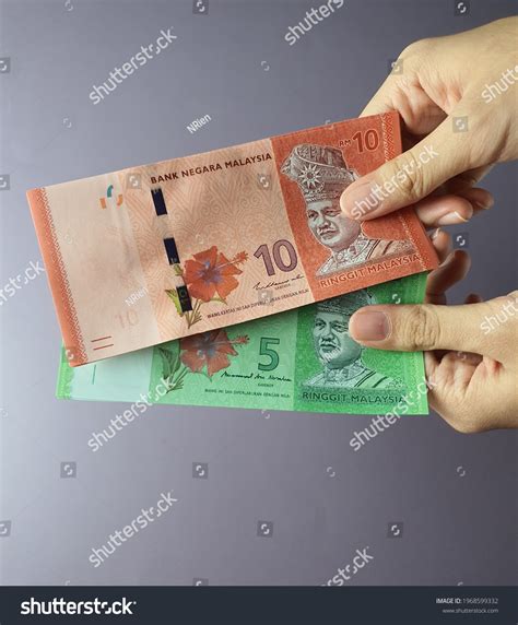 Hands Holding Malaysian Ringgit Currency Notes Stock Photo 1968599332