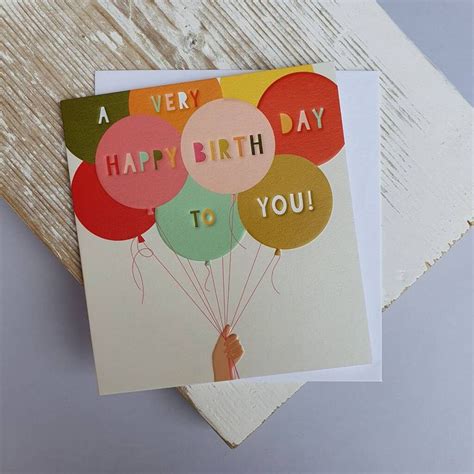 A Happy Birthday Card With Colorful Balloons On The Front And A Hand