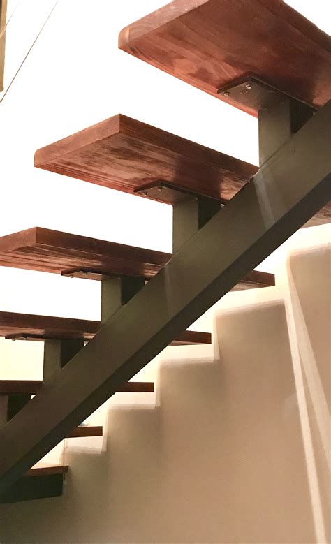 Modern Stairs Detail With Wood Handrails And Metal Rails