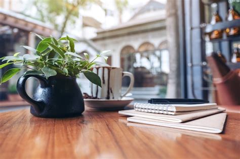 Premium Photo Notebooks Pen And Coffee Cup On Wooden Table