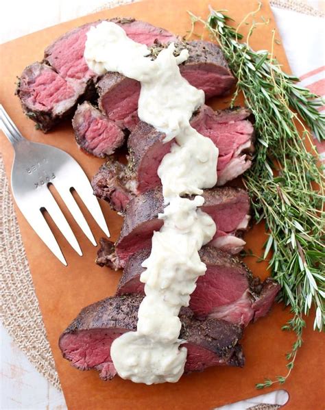 Steak With White Sauce And Fresh Herbs On An Orange Cutting Board Next