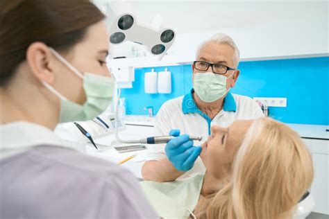 Male Orthodontist Doing Correctly Treatment Above Oral Cavity In Dental