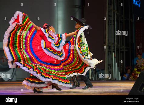 A Traditional Mexican Jalisco Dancer Spreading Her Colorful Red Dress Dancing In Front Of Her