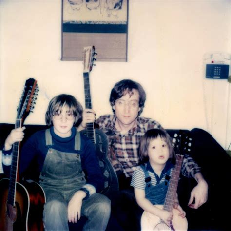 John Lennon sitting with his sons Julian and Sean Lennon, 1977.